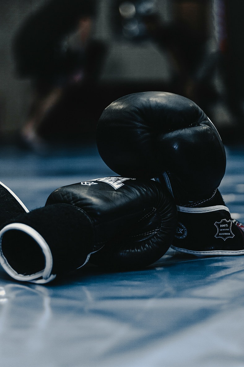 black boxing gloves on blue floor