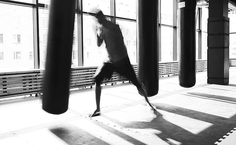 man hitting a punching bag