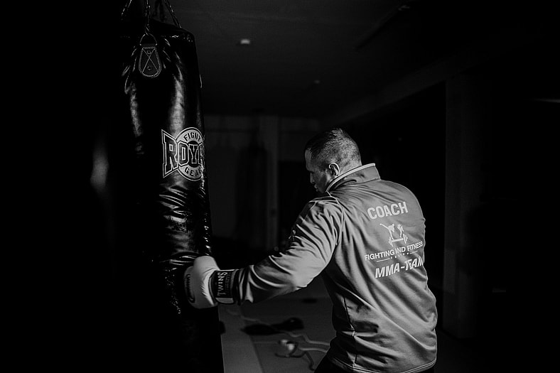 man hitting punch bag