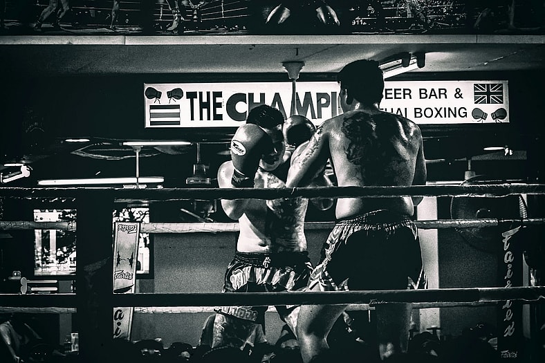 two men fighting in the ring black and white