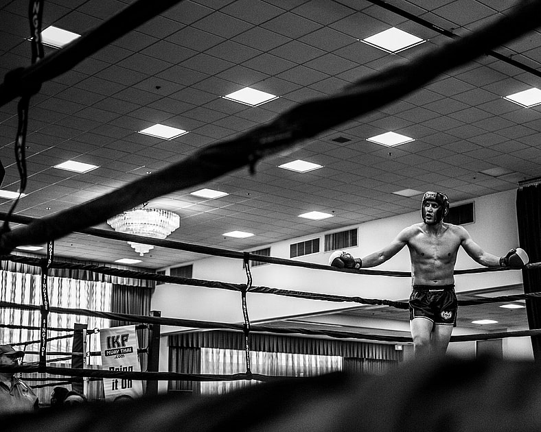 man standing in boxing ring black and white