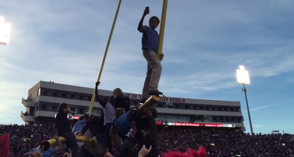 Ole Miss fans climb the goalpost after defeating Alabama in 2014
