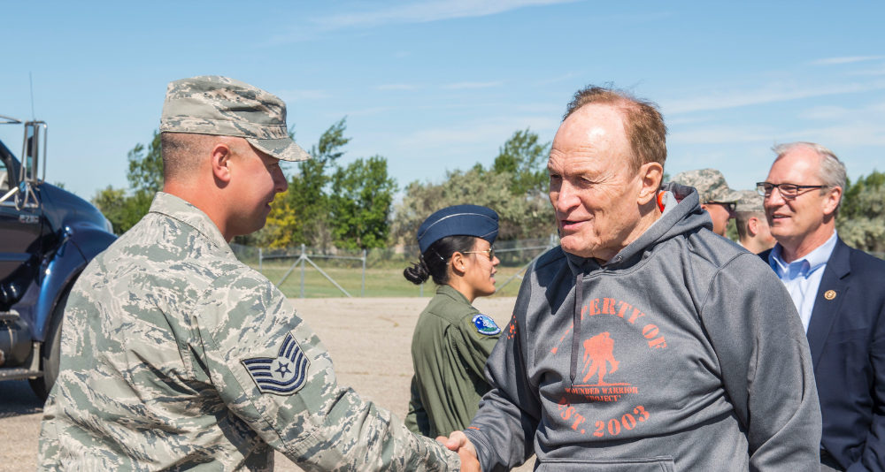Dale Brown, former college basketball coach, is greeted by Airmen from the 91st Missile Wing.