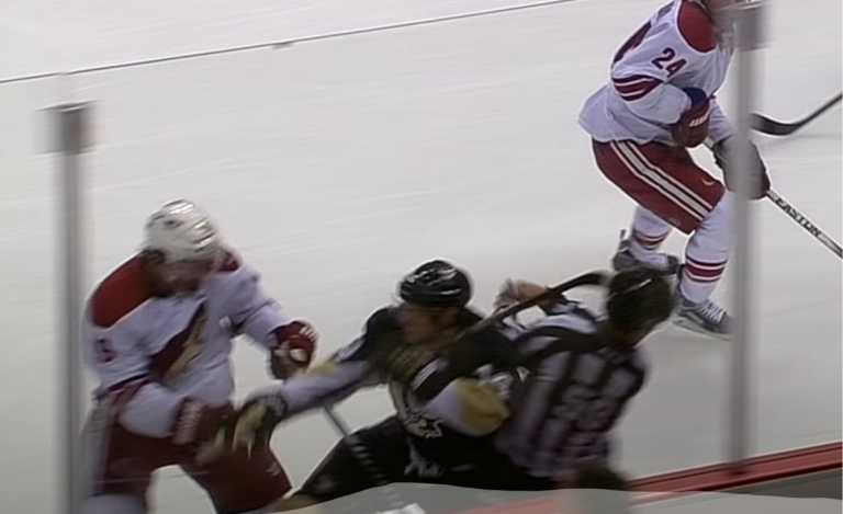 NHL official Steve Barton takes an errant stick to the face from Penguins Chris Kunitz